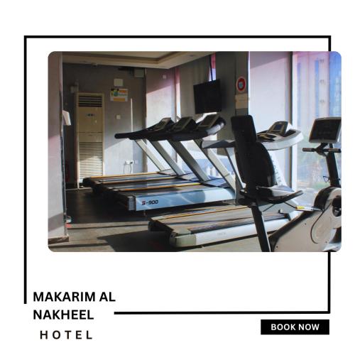 a gym with a row of treadmills at Makarim Palm Hotel in Rabigh
