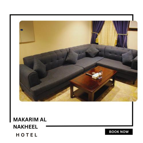 a living room with a couch and a coffee table at Makarim Palm Hotel in Rabigh