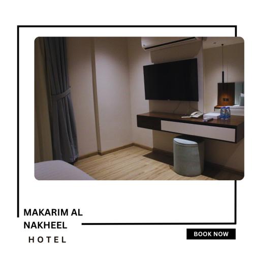 a hotel room with a bed and a television at Makarim Palm Hotel in Rabigh