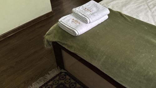 two towels are sitting on top of a bed at Kirch Hotel & Restaurant in Goris