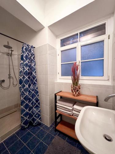 a bathroom with a sink and a shower and a window at City Retreat 13 1 in Eisenstadt