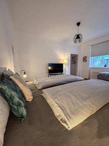 a bedroom with two beds and a piano in it at City Retreat 13 1 in Eisenstadt