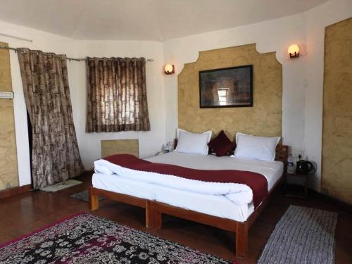 a bedroom with a large bed in a room at Jawai Wildlife Safari Camp in Nāna