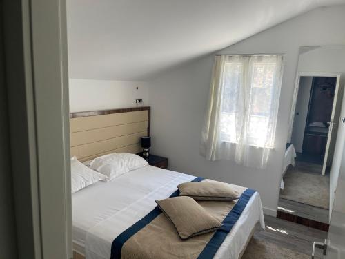 a bedroom with a large bed and a window at Mediteraneo in Dubrovnik