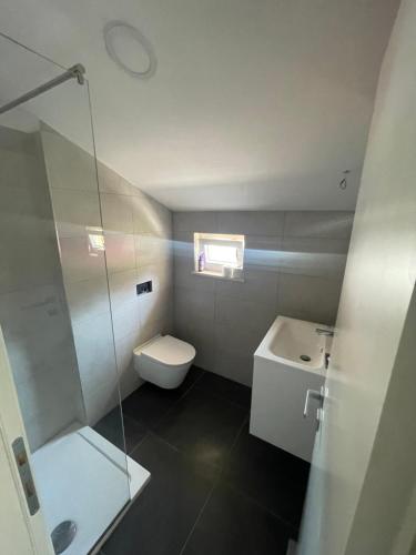 a bathroom with a toilet and a sink and a shower at Mediteraneo in Dubrovnik