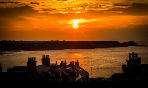 a sunset over a body of water with the sun at Salt View in Cullen