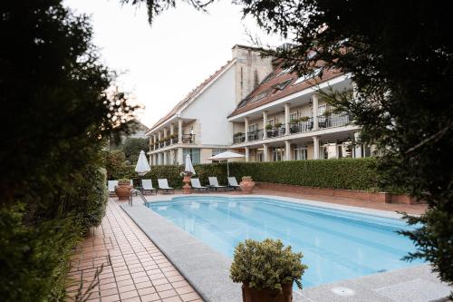 a large swimming pool in front of a building at Villa Covelo in Poio
