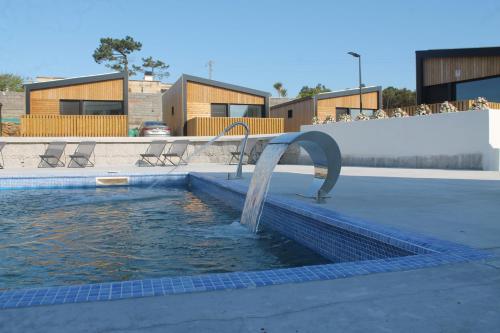 a pool with a water fountain in a building at Top Balea in Pontevedra