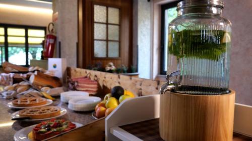 a kitchen counter with a jar filled with green liquid at Villa Emma in Nago-Torbole