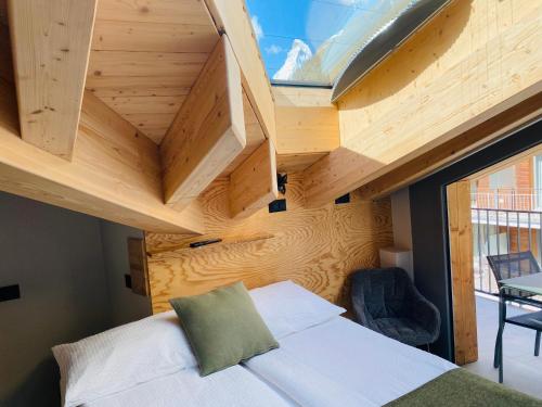 a small bedroom with a bed in a tiny house at Peaky Riders Self Check-in Hotel in Zermatt