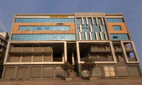 a tall building with a sign on the front of it at Treebo Trend Eden Park, Ahmedabad in Ahmedabad