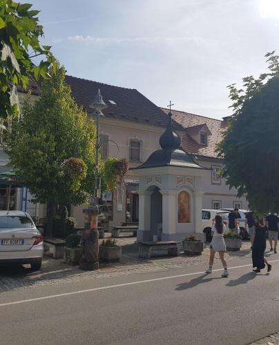 a group of people crossing a street in front of a building at Trg Mozirje in Mozirje