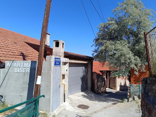 a building with a gate and a garage at Apartman Biser in Sarajevo