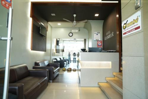 a lobby with couches and a bar in a hospital at HOTEL GRANDEUR in Valsad