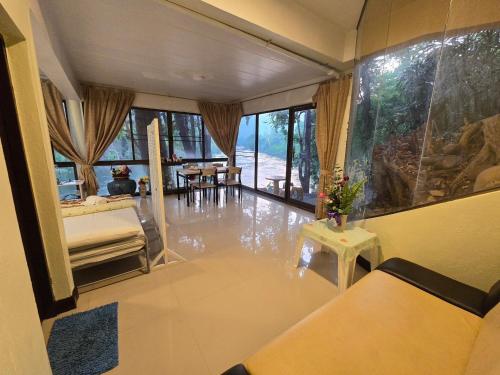 a view of a living room with water on the floor at Puprai Tarnnarm Resort in Thong Pha Phum