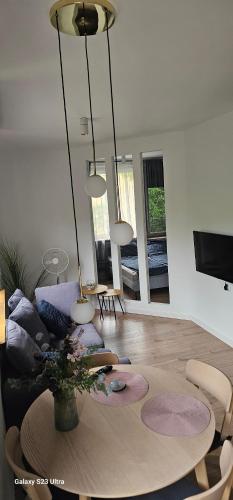 a living room with a table and chairs at Apartament Kochanowskiego in Oświęcim