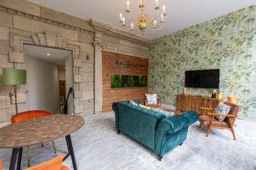 a living room with a couch and a tv at The Resolution Hotel in Whitby