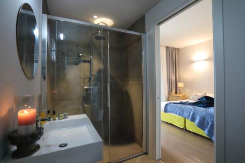 a bathroom with a shower and a sink and a bed at Agriturismo Le Piccole Macìe in Magliano in Toscana