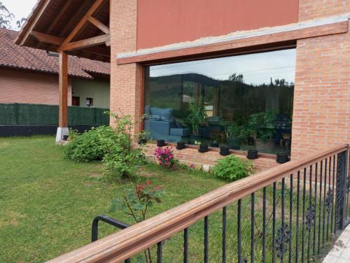 a balcony with a view of a living room at La Casa Malvarrosa in Ampuero