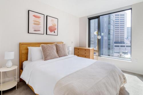 a bedroom with a white bed and a large window at Soma 1br w concierge theater on-site retail SFO-1472 in San Francisco