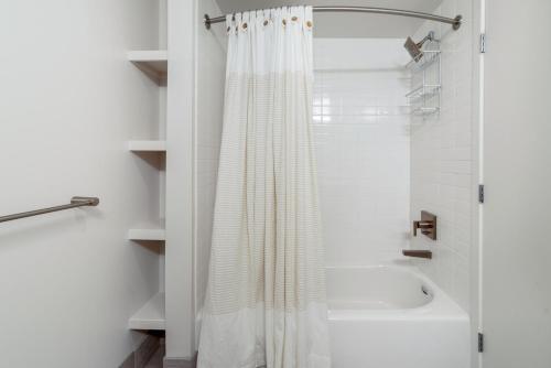 a bathroom with a shower curtain and a bath tub at Soma 1br w concierge theater on-site retail SFO-1472 in San Francisco