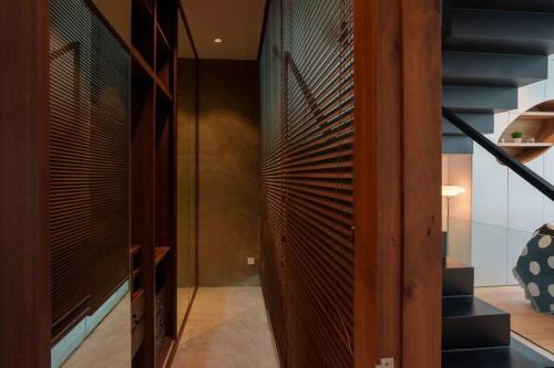 a staircase in a house with a wooden wall at Georgetown Minimalist Elegance 4BR 8Pax in George Town