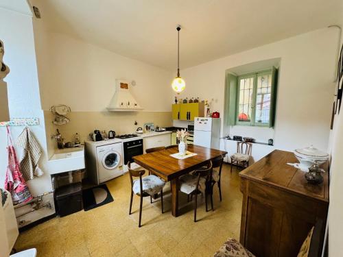 a kitchen with a table and a dining room at Casa Victoria in Tremezzo