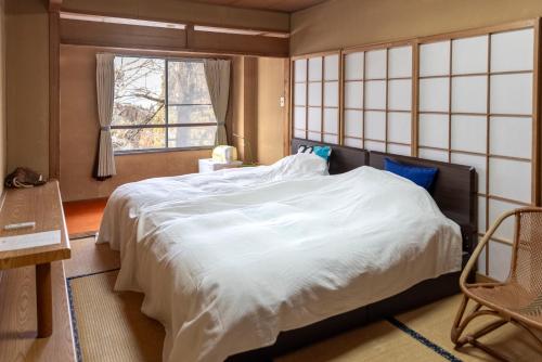 Een bed of bedden in een kamer bij Kogakuro
