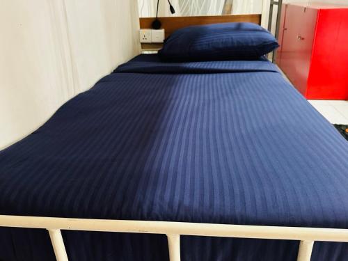 a bed in a room with a blue mattress at Rock View Hostel Ella in Ella