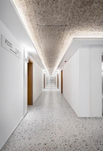 an empty corridor in an office building with white walls and ceilings at Grand Hotel Sunny Beach - All Inclusive in Sunny Beach