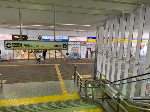 an empty airport with people walking through a terminal at Alaula in Izumi-Sano