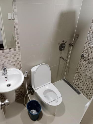 a bathroom with a toilet and a sink at Hotel Sogo Mindanao Avenue in Manila