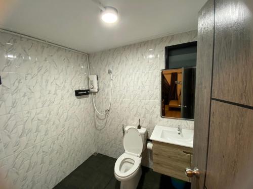 a bathroom with a toilet and a sink at Freedom home khaokho in Khao Kho