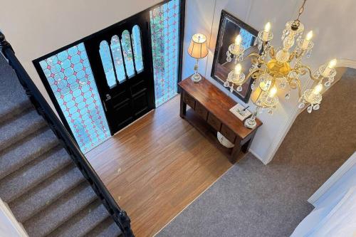 an overhead view of a staircase with a chandelier at 5Rooms life-style in City—“Golden Harvest Retreat” in Matangi
