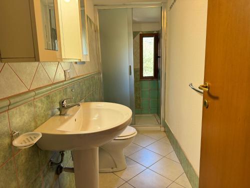 a bathroom with a sink and a toilet at Casa Giliè A in Santa Maria Navarrese