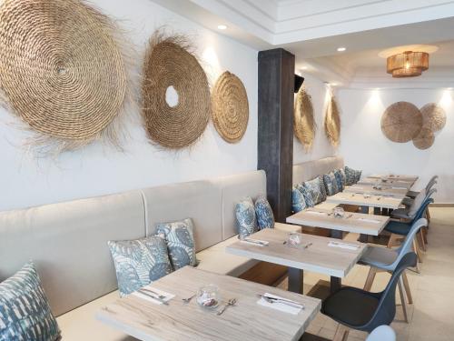 a row of tables and chairs in a restaurant at Flacalco Hotel & Apartments in Cala Ratjada