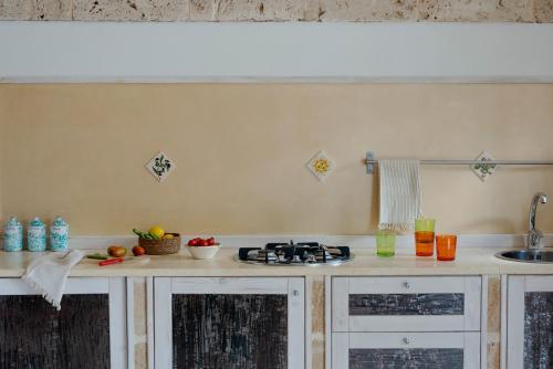 a kitchen with a sink and a counter top at Dimore Opuntia in Spongano
