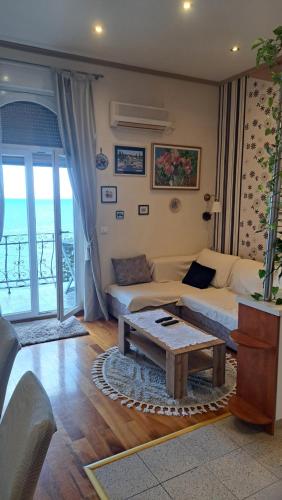 a living room with a couch and a coffee table at Apartment Roberta in Lovran