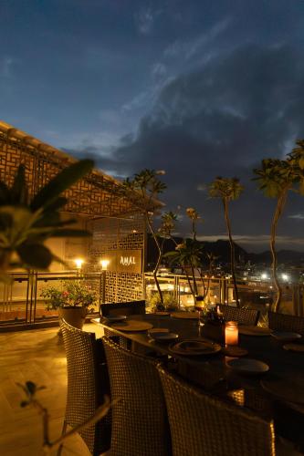 a restaurant with tables and chairs at night at Aura Boutique Hotel in Udaipur