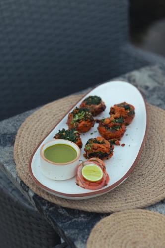 a plate of food sitting on top of a table at Aura Boutique Hotel in Udaipur
