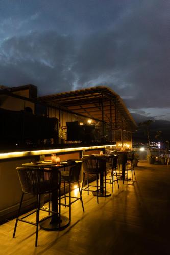 a group of tables and chairs on a rooftop at night at Aura Boutique Hotel in Udaipur