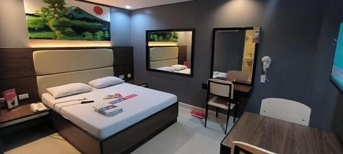 Postel nebo postele na pokoji v ubytování Hotel Sogo Davao