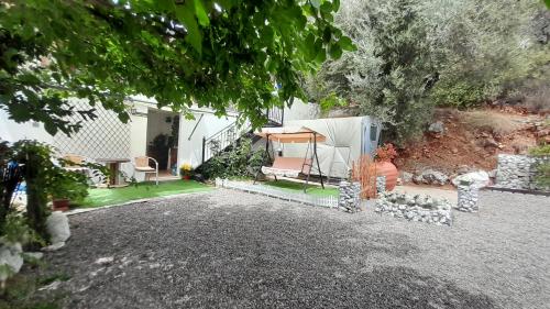 a yard with a house with a tent at George house in Leonidion