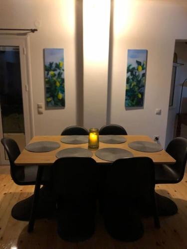 a wooden table with chairs and a candle on it at Lemon tree in Filiatra