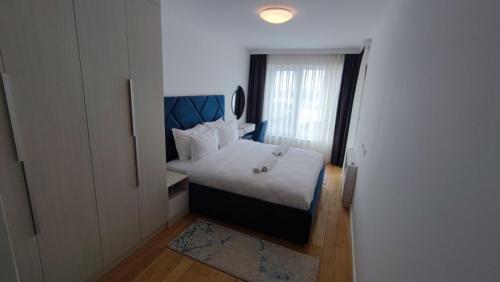 a bedroom with a bed and a window at Apartment Lana in Sarajevo
