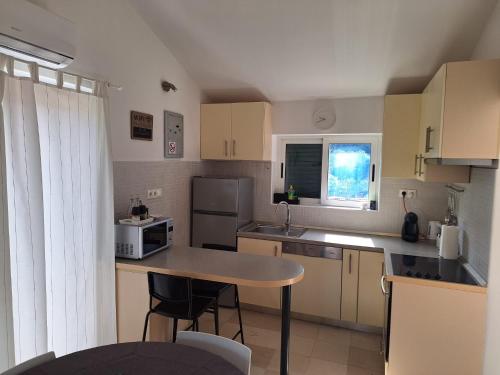a small kitchen with a table and a microwave at Pension Oaza in Hvar