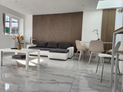 a living room with a couch and a table and chairs at Spacious and bright one bedroom apartment in Oxford