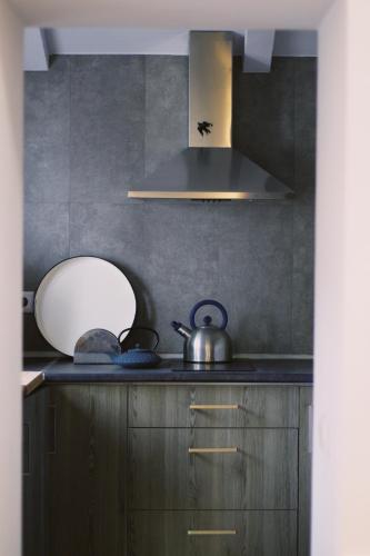a kitchen with a tea kettle on the counter at Casa Oliva-Casa da Eira in Porto de Mós