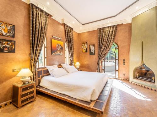 a bedroom with a bed and a fireplace at Lion's Palace Marrakech in Marrakesh