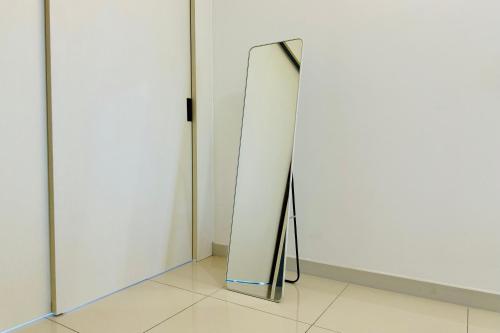 a mirror in front of a white wall at Comfy-Concept Apartment @ B.Bintang (3min walk LRT, Lalaport, TimeSquare) in Kuala Lumpur